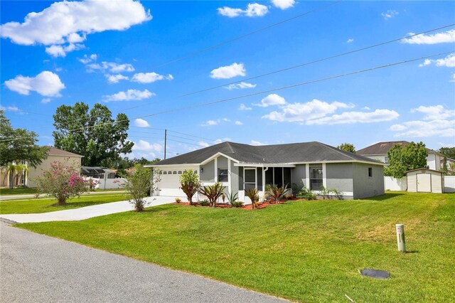 845 Valnera Ct, Kissimmee, FL 34758 - ranch-style house with driveway, a front yard, stucco siding, a garage, and a storage unit