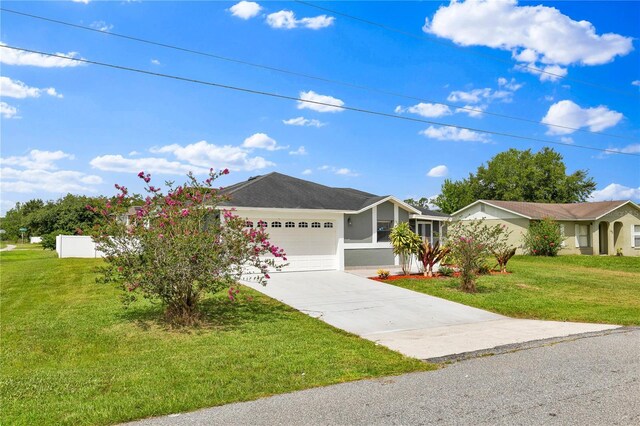 845 Valnera Ct, Kissimmee, FL 34758 - ranch-style house with an attached garage, driveway, a front lawn, and stucco siding