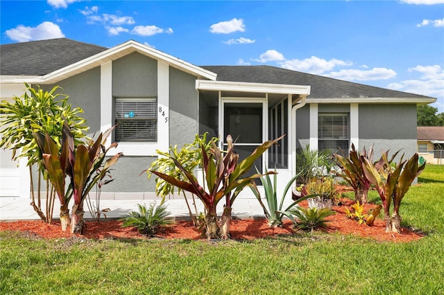 845 Valnera Ct, Kissimmee, FL 34758 - view of front of property featuring a front lawn, stucco siding, a shingled roof, and a sunroom
