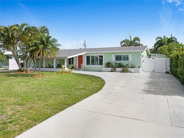 231 Ocean Blvd, Satellite Beach, FL 32937 - view of front of home featuring a gate, driveway, stucco siding, and a front yard