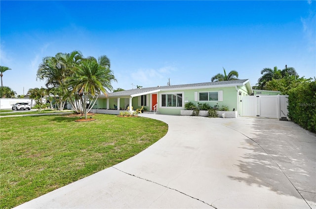231 Ocean Blvd, Satellite Beach, FL 32937 - ranch-style home featuring a gate, curved driveway, a front yard, and stucco siding
