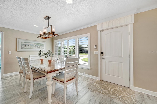 231 Ocean Blvd, Satellite Beach, FL 32937 - dining room with crown molding, a chandelier, a textured ceiling, light wood-type flooring, and recessed lighting