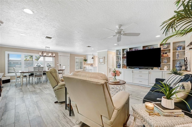 231 Ocean Blvd, Satellite Beach, FL 32937 - living area with ceiling fan, a textured ceiling, light wood-type flooring, recessed lighting, and a chandelier