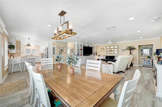 231 Ocean Blvd, Satellite Beach, FL 32937 - dining room with crown molding, light wood-style floors, a textured ceiling, ceiling fan, and recessed lighting