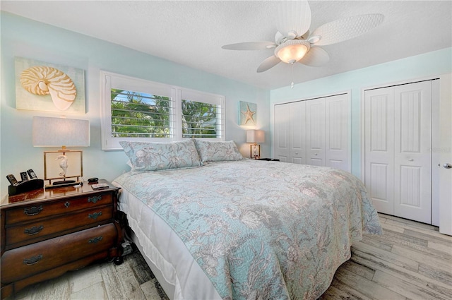 231 Ocean Blvd, Satellite Beach, FL 32937 - bedroom with multiple closets, wood finished floors, a ceiling fan, and a textured ceiling