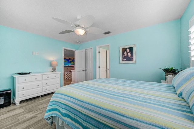 231 Ocean Blvd, Satellite Beach, FL 32937 - bedroom featuring wood finished floors, a ceiling fan, a closet, and a textured ceiling