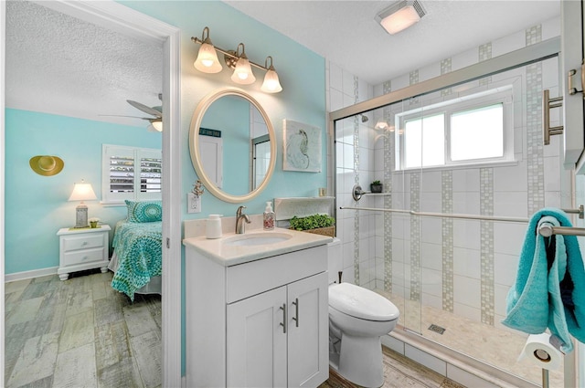 231 Ocean Blvd, Satellite Beach, FL 32937 - full bath with ceiling fan, a textured ceiling, vanity, a shower stall, and ensuite bath