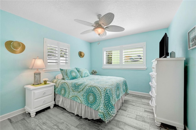 231 Ocean Blvd, Satellite Beach, FL 32937 - bedroom featuring light wood-style flooring, a textured ceiling, and ceiling fan