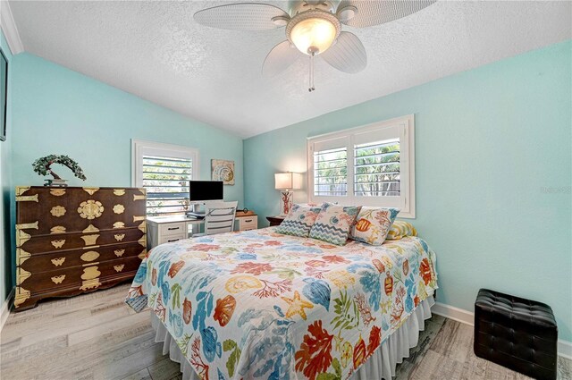 231 Ocean Blvd, Satellite Beach, FL 32937 - bedroom with light wood-style floors, lofted ceiling, a textured ceiling, and ceiling fan