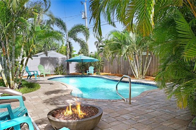 231 Ocean Blvd, Satellite Beach, FL 32937 - view of pool with a patio area, a fenced backyard, and a fire pit