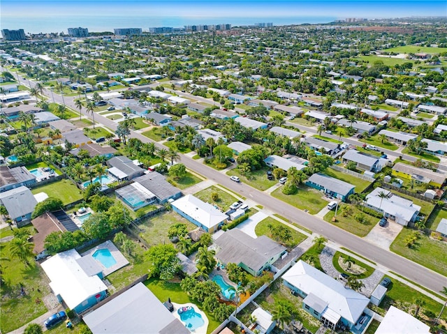 231 Ocean Blvd, Satellite Beach, FL 32937 - aerial overview of property's location with nearby urban area and a pool area