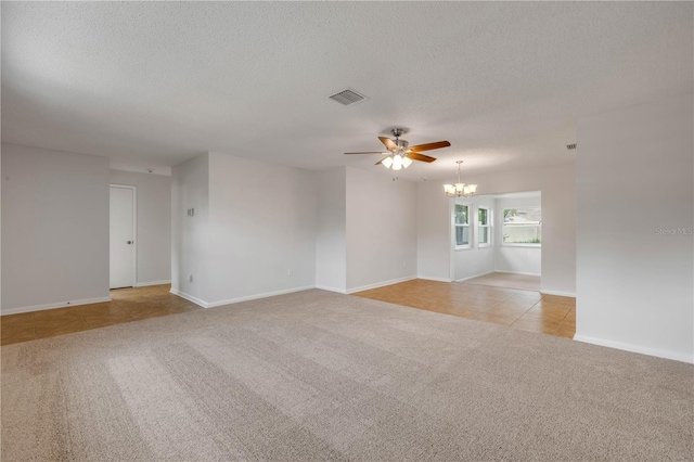 879 Tamerlane St, Deltona, FL 32725 - spare room featuring light carpet, a chandelier, a ceiling fan, a textured ceiling, and light tile patterned floors