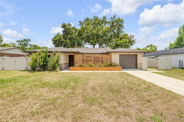 879 Tamerlane St, Deltona, FL 32725 - view of front facade featuring a gate, driveway, an attached garage, and stucco siding