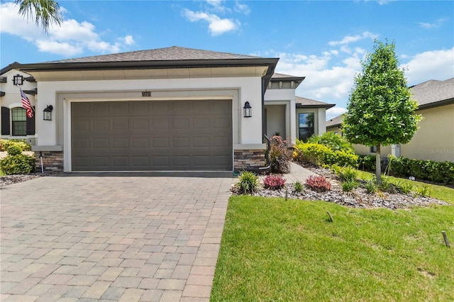 971 Braewood Dr, Clermont, FL 34715 - view of front of house with stone siding, stucco siding, decorative driveway, and a garage