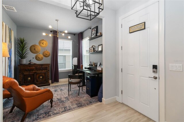 971 Braewood Dr, Clermont, FL 34715 - home office with a chandelier and light wood-type flooring