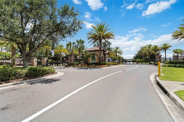 971 Braewood Dr, Clermont, FL 34715 - view of asphalt street featuring a gate, curbs, and a gated entry