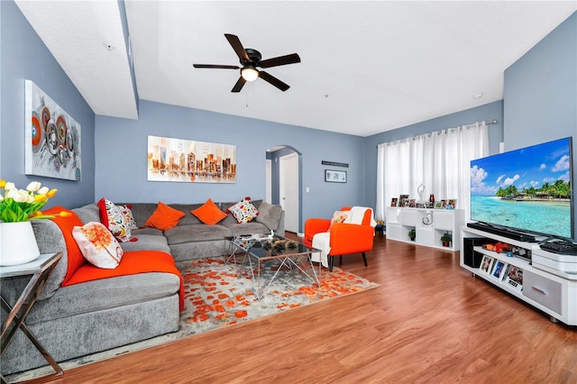 5566 Metrowest Blvd Unit 10, Orlando, FL 32811 - living room featuring arched walkways, wood finished floors, and a ceiling fan