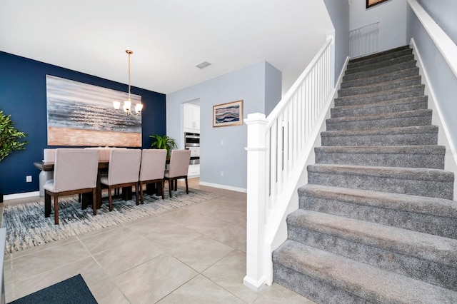 609 Big Pine Ave, Minneola, FL 34715 - staircase featuring a chandelier and tile patterned floors
