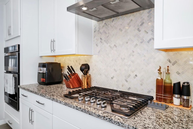 609 Big Pine Ave, Minneola, FL 34715 - kitchen with extractor fan, appliances with stainless steel finishes, tasteful backsplash, and white cabinets