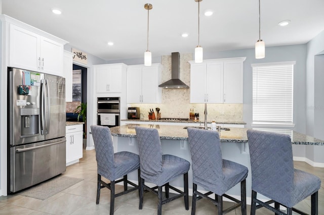 609 Big Pine Ave, Minneola, FL 34715 - kitchen featuring appliances with stainless steel finishes, wall chimney exhaust hood, backsplash, white cabinets, and recessed lighting
