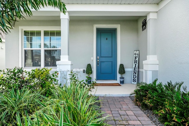 609 Big Pine Ave, Minneola, FL 34715 - doorway to property featuring stucco siding and a porch