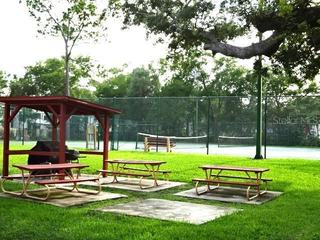 2864 N Powers Dr Unit 156, Orlando, FL 32818 - view of home's community with a tennis court