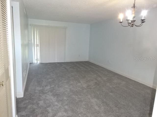2864 N Powers Dr Unit 156, Orlando, FL 32818 - carpeted spare room with a chandelier and baseboards