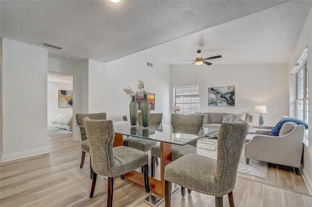 1921 Heathwood Dr, Winter Park, FL 32792 - dining area with light wood finished floors, plenty of natural light, a ceiling fan, and a textured ceiling