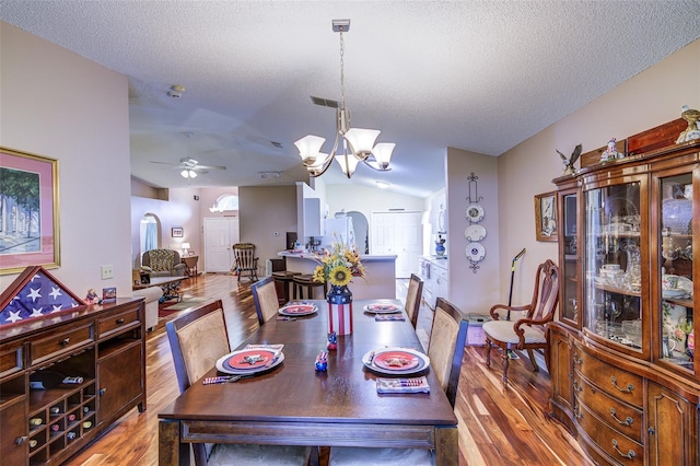 2031 Wekiva Reserve Blvd, Apopka, FL 32703 - dining room featuring vaulted ceiling, arched walkways, wood finished floors, a chandelier, and ceiling fan