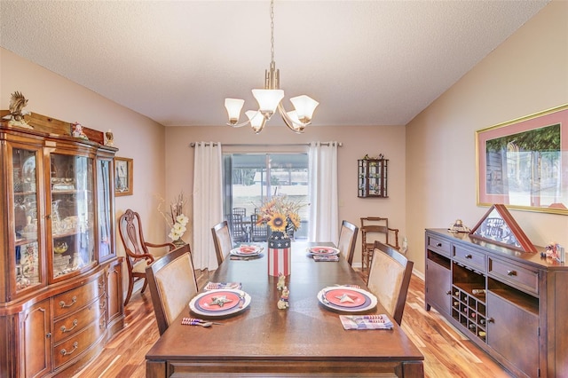 2031 Wekiva Reserve Blvd, Apopka, FL 32703 - dining room featuring a chandelier, light wood-style floors, and a textured ceiling