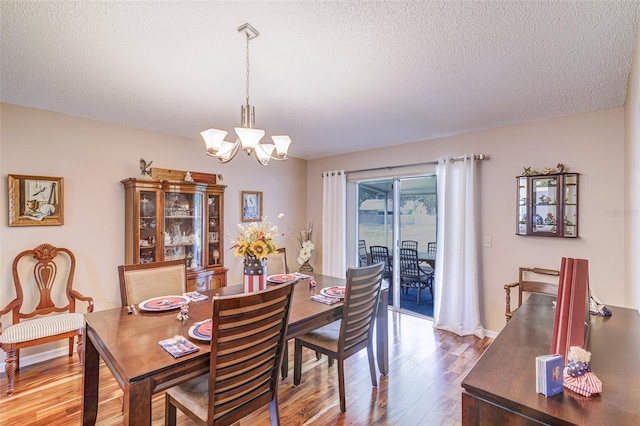 2031 Wekiva Reserve Blvd, Apopka, FL 32703 - dining area featuring wood-type flooring, a chandelier, and a textured ceiling