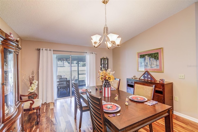 2031 Wekiva Reserve Blvd, Apopka, FL 32703 - dining room featuring a chandelier, light wood-style flooring, and a textured ceiling