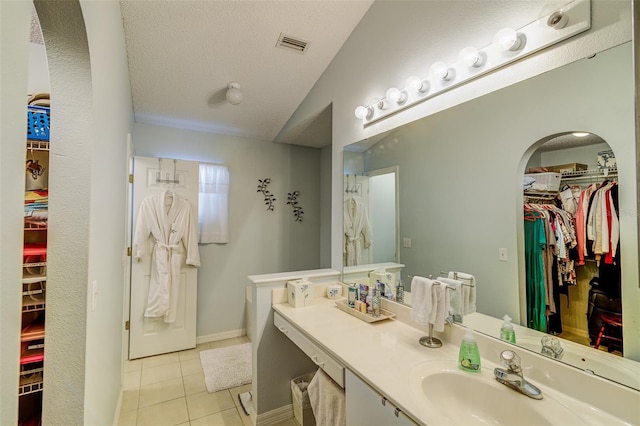 2031 Wekiva Reserve Blvd, Apopka, FL 32703 - bathroom featuring a walk in closet, vaulted ceiling, tile patterned floors, and vanity
