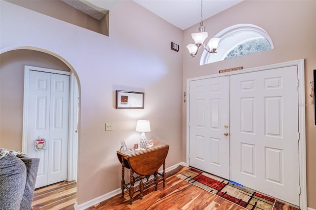 2031 Wekiva Reserve Blvd, Apopka, FL 32703 - entryway featuring light wood-style flooring, a chandelier, arched walkways, and a high ceiling