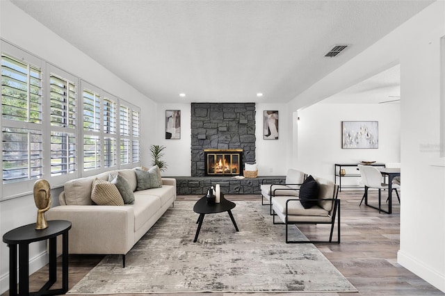 608 Pearl Rd, Winter Springs, FL 32708 - living area with wood finished floors, recessed lighting, a fireplace, and a textured ceiling
