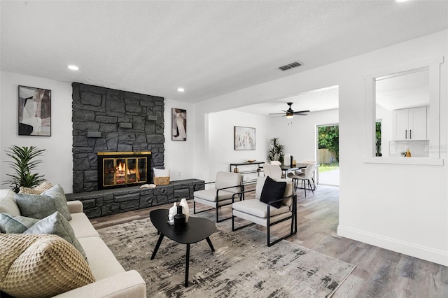 608 Pearl Rd, Winter Springs, FL 32708 - living room with wood finished floors, ceiling fan, a fireplace, recessed lighting, and a textured ceiling