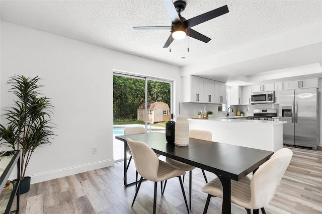 608 Pearl Rd, Winter Springs, FL 32708 - dining space with a ceiling fan, a textured ceiling, and light wood-type flooring