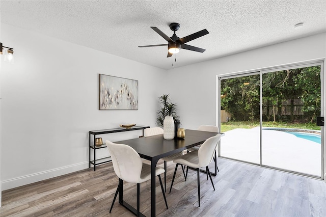 608 Pearl Rd, Winter Springs, FL 32708 - dining room with wood finished floors, ceiling fan, and a textured ceiling