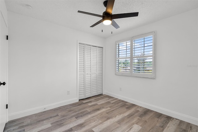 608 Pearl Rd, Winter Springs, FL 32708 - unfurnished bedroom featuring wood finished floors, a closet, a ceiling fan, and a textured ceiling