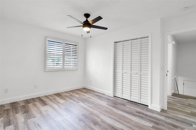 608 Pearl Rd, Winter Springs, FL 32708 - unfurnished bedroom featuring wood finished floors, a closet, a textured ceiling, and ceiling fan