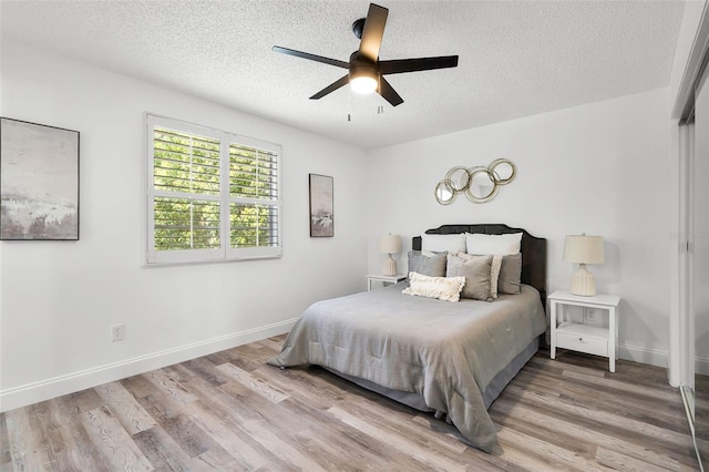 608 Pearl Rd, Winter Springs, FL 32708 - bedroom featuring a textured ceiling, wood finished floors, a ceiling fan, and a closet