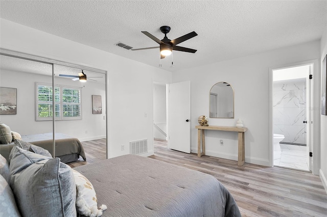608 Pearl Rd, Winter Springs, FL 32708 - bedroom with wood finished floors, a textured ceiling, connected bathroom, a closet, and a ceiling fan