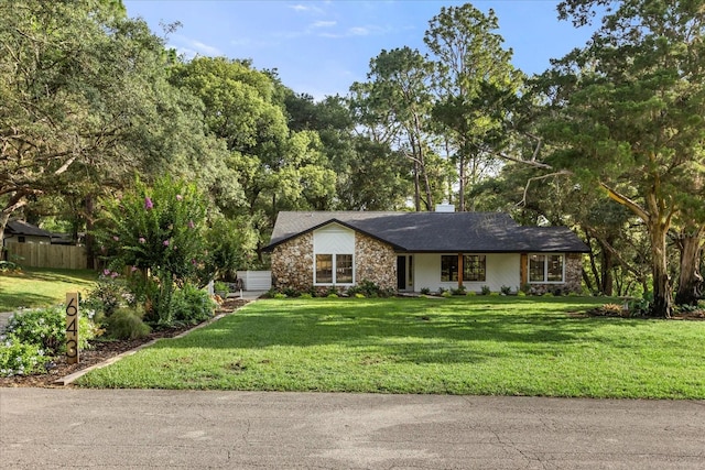 643 Princewood Dr, Deland, FL 32724 - view of front facade with stone siding and a chimney