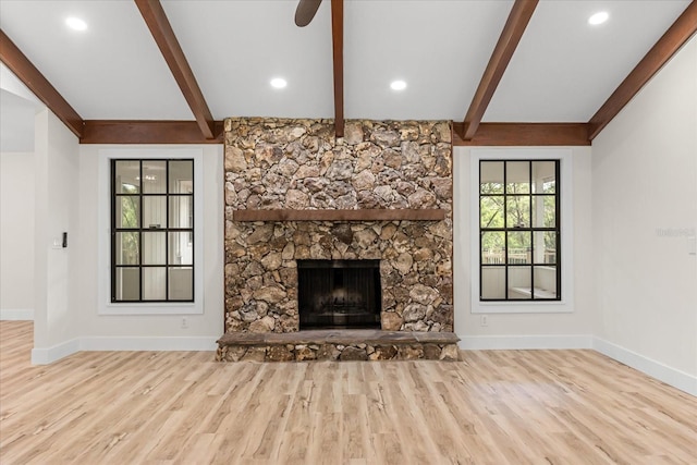 643 Princewood Dr, Deland, FL 32724 - unfurnished living room featuring wood finished floors, beam ceiling, a stone fireplace, and a ceiling fan