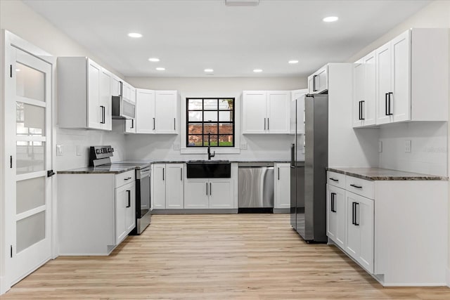 643 Princewood Dr, Deland, FL 32724 - kitchen featuring appliances with stainless steel finishes, light wood-style flooring, recessed lighting, and white cabinetry