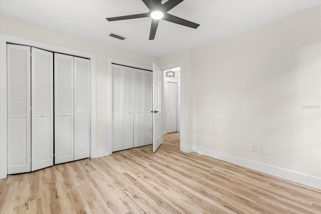 643 Princewood Dr, Deland, FL 32724 - unfurnished bedroom with multiple closets, light wood-style floors, and ceiling fan