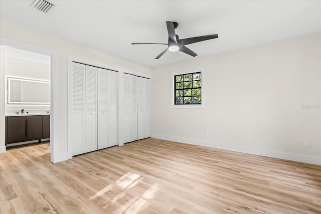 643 Princewood Dr, Deland, FL 32724 - unfurnished bedroom with multiple closets, light wood-type flooring, ensuite bathroom, and a ceiling fan