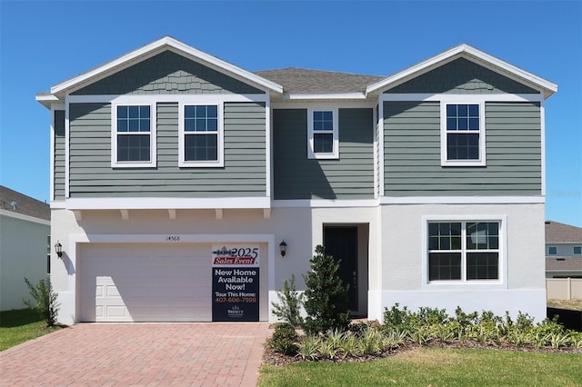 14568 Crestavista Ave, Clermont, FL 34714 - view of front of property with a garage, decorative driveway, and stucco siding