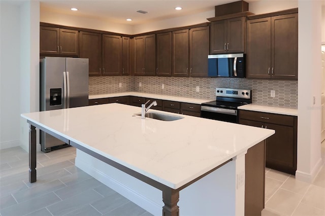 14568 Crestavista Ave, Clermont, FL 34714 - kitchen featuring appliances with stainless steel finishes, dark brown cabinets, decorative backsplash, light tile patterned flooring, and recessed lighting