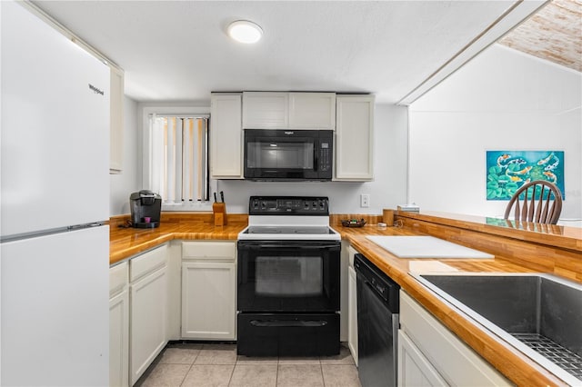 1051 S Highland St Unit 7D, Mount Dora, FL 32757 - kitchen with freestanding refrigerator, black microwave, range with electric stovetop, dishwasher, and light tile patterned floors